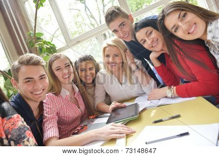 happy young teens group in school on chemisty lessons and library education