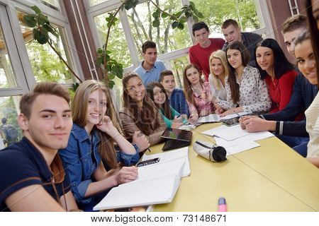 happy young teens group in school on chemisty lessons and library education