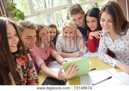 happy young teens group in school on chemisty lessons and library education