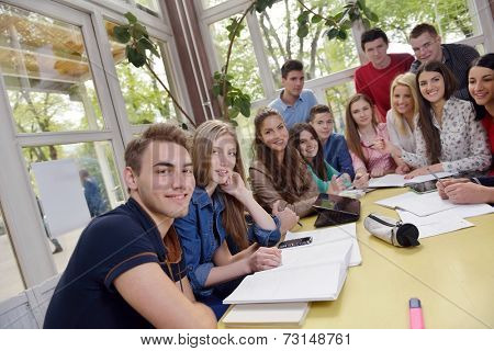 happy young teens group in school on chemisty lessons and library education