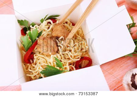 Chinese noodles in takeaway box closeup