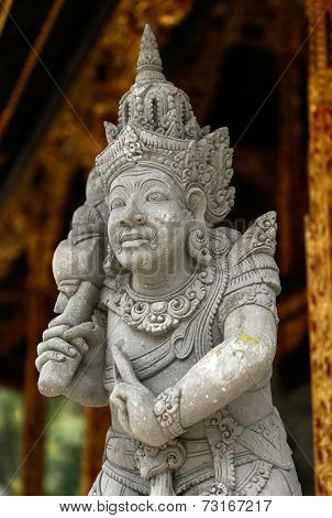 Stone sculpture of Balinese Hindu god inside the Tirta Empul Temple.