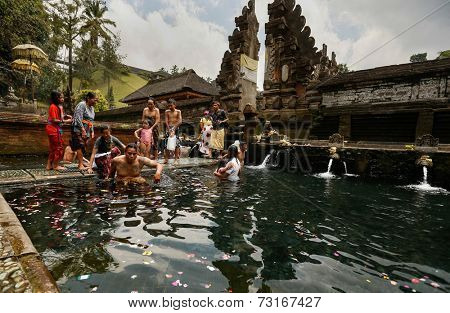SEPTEMBER 18, 2014 - BALI, INDONESIA: Devotees bathe in the temple pool of Pura Tirta Empul in a cleansing and purification ceremony. Hinduism is the religion of the Balinese people.