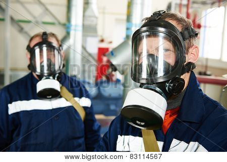 portrait of service engineer worker with gas mask at industrial compressor station for refrigeration or ammoniac chiller system at factory