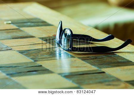 Pair Of Glasses On A Checkered Table