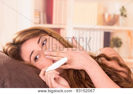 nervous young girl holding pregnancy test