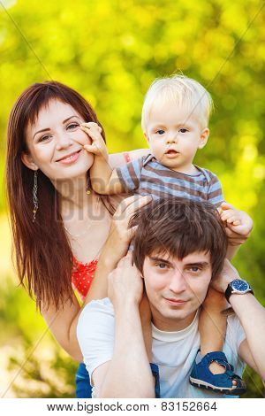 Happy young family spending time outdoor on a summer day