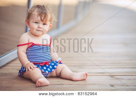 Rural girl playing alone in the street in the summer.