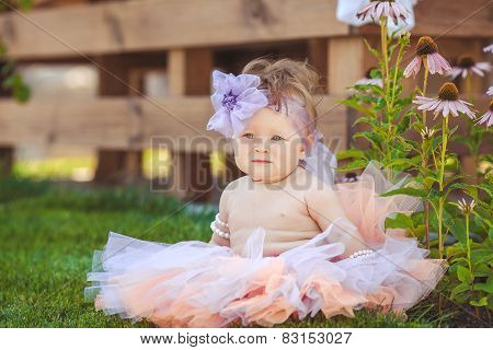 Rural girl playing alone in the street in the summer.