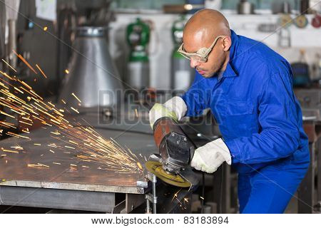 Worker Grinding A Piece Of Metal With Angle Gringer
