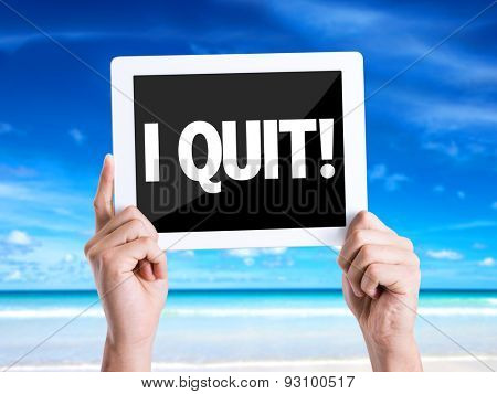 Tablet pc with text I Quit with beach background