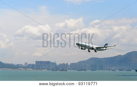 HONG KONG - JUNE 04, 2015: Cathay Pacific aircraft landing. Cathay Pacific is the flag carrier airline of Hong Kong, with its head office and main hub located at Hong Kong International Airport