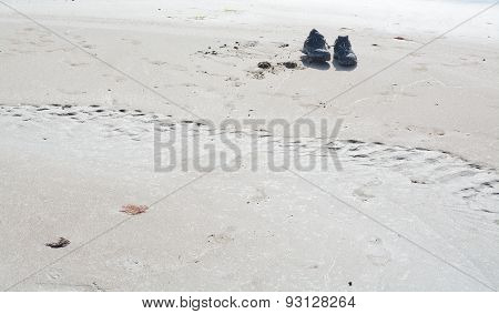 Sandy beach landscape with two shoes