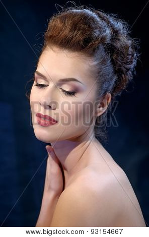 Young Woman Touching Her Face Over Blue Dark Background.