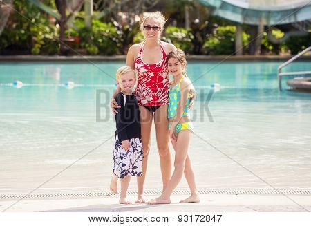 Cute Family at a large outdoor swimming pool