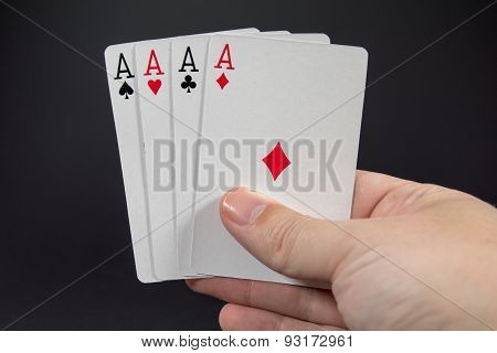 A Hand Holding The Four Aces From a deck of cards