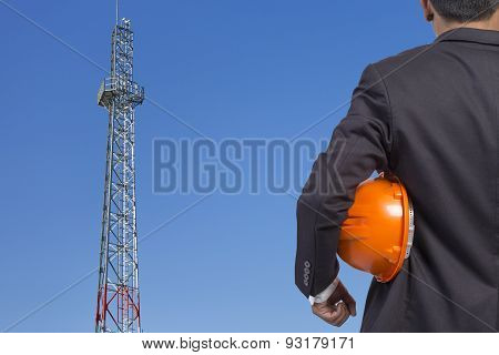 Engineer Holding Orange Helmet For Workers Security On Contruction Background
