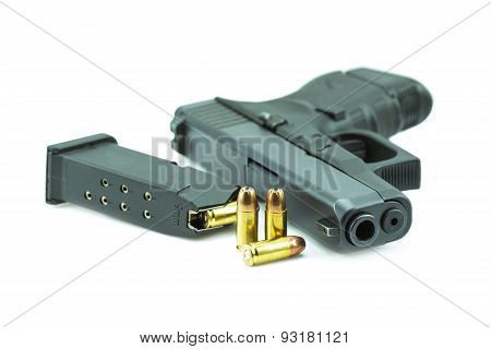 9mm bullets and black gun pistol isolated on white background.
