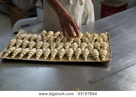 Baker Counting Croissants On A Tray