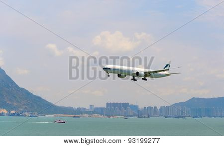 HONG KONG - JUNE 04, 2015: Cathay Pacific aircraft landing. Cathay Pacific is the flag carrier airline of Hong Kong, with its head office and main hub located at Hong Kong International Airport