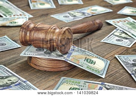 Judges Or Auctioneers Gavel And Money Stack On Wooden Background