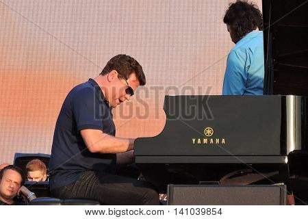 MOSCOW - AUGUST 01, 2016: Piano player Denis Matsuev performs at open air free entrance concert at VDNH park in Moscow. Celebration of VDNH foundation anniversary (77 years).