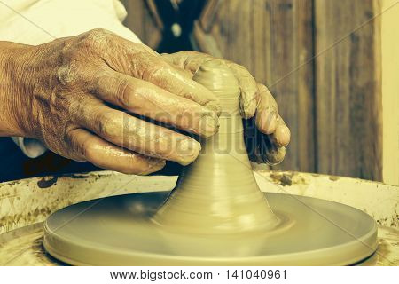Close Up Of  Mature Potter Hands At Work