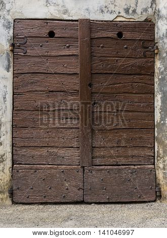 Old brown door in Borgo Villa il Poggio Piedmont Italy.