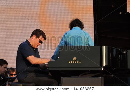 MOSCOW - AUGUST 01, 2016: Piany player Denis Matsuev performs at open air free entrance concert at VDNH park in Moscow. Celebration of VDNH foundation anniversary (77 years).