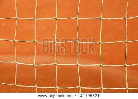 Old Net With The Ground And White Line Tennis Court. Dry Red Clay. Light Red Crushed Bricks Surface