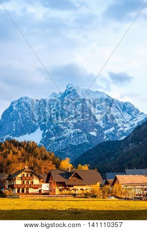 Beautiful landscape with village and snowed up mountains near Triglav national park in Slovenia. Traveling slovenian Alps