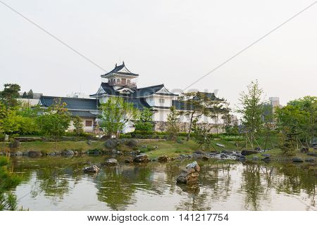Toyama Castle With Beautiful Garden And Reflection In Water.