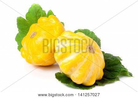 two yellow pattypan squash with leaf isolated on white background.
