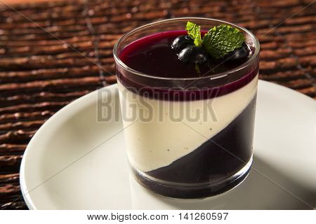 Italian Dessert Pannacotta With Redfruit And Mint.