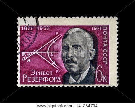 USSR - CIRCA 1971: cancelled stamp printed in the USSR shows famous scientist British physicist Ernest Rutherford (1871-1937) and diagram of movement of atomic particles, circa 1971. vintage post stamp on black background.
