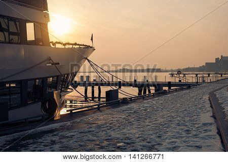 ontario sunset; ship in rays of sun; sunset on lake; ontario pier; yacht on water; boat in harbor of Toronto