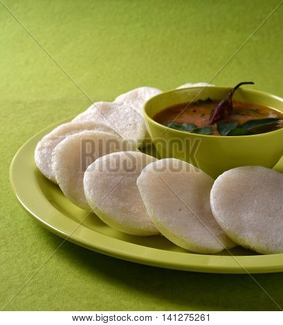 Idli with Sambar in bowl on green background, Indian Dish : south Indian food