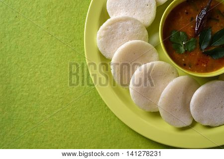 Idli With Sambar In Bowl On Green Background, Indian Dish : South Indian Favourite Food Rava Idli Or