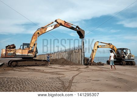 Excavator Build Breakwater At Beach