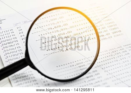 Magnifier and book bank on white background.