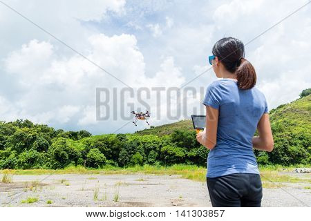 Woman control flying drone at outdoor