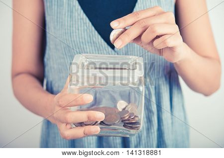 hands holding piggy bank show money dollar bills and coin in piggy bank. business savings finance concept