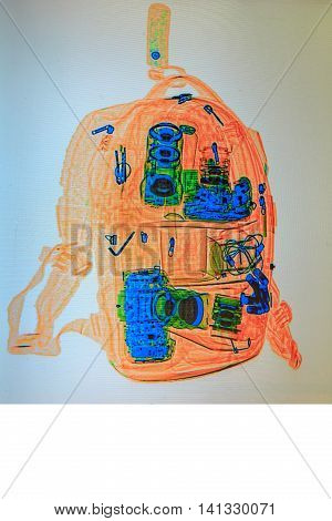 the photographer's backpack under a X-ray. check of baggage at the airport.Camera and lenses. check of baggage at the airport.