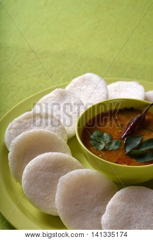 Idli With Sambar In Bowl On Green Background, Indian Dish : South Indian Favourite Food Rava Idli Or