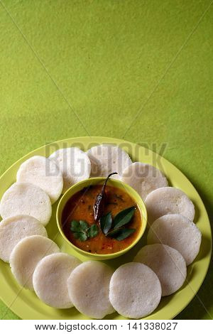 Idli With Sambar In Bowl On Green Background, Indian Dish : South Indian Favourite Food Rava Idli Or