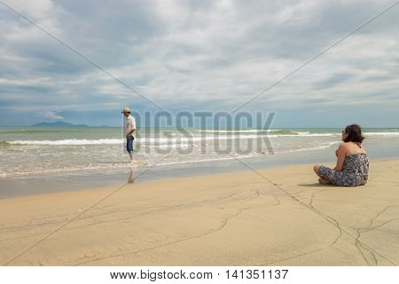 Man And Woman Looking Into Sea Of China Beach Danang