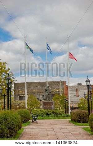 TIGRE, ARGENTINA - MAY 02, 2016: the statue of Manuel Belgrano with argentina's flag behind in one park of the city