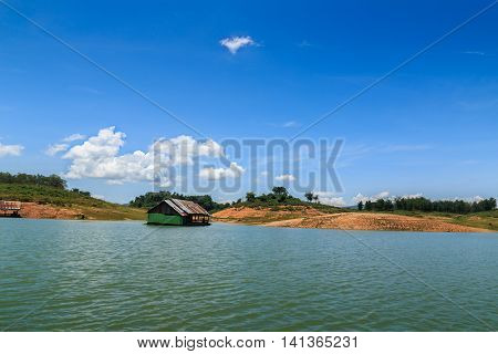 View riverside with blue skyclouds and raft in countryside