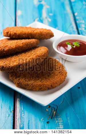 Indian chat item aloo or aalu tikki or tikiya or fried potato cake also known as ragda patties served with tomato ketchup, selective focus
