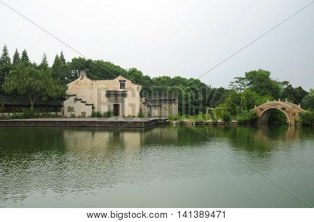 The water theater stage and arched bridge within Tongxiang's West Wuzhen Scenic Area in Zhejiang province China.